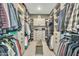 Spacious walk-in closet with custom shelving, drawers, and ample storage space at 2205 E Fallen Leaf Ln, Phoenix, AZ 85024