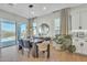 Modern dining room next to sliding glass doors leading to a patio with a pool at 2205 E Fallen Leaf Ln, Phoenix, AZ 85024