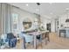 Elegant dining room with modern lighting and a view into the kitchen at 2205 E Fallen Leaf Ln, Phoenix, AZ 85024