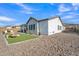 The backyard features a covered patio, pool, turf and rock landscaping, combining comfort and convenience at 2205 E Fallen Leaf Ln, Phoenix, AZ 85024