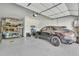 This expansive garage showcases a car lift, sleek epoxy flooring, and ample space for multiple vehicles at 2205 E Fallen Leaf Ln, Phoenix, AZ 85024