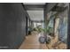 Stylish hallway with dark gray walls, plant accents, leading to a bright living space at 2205 E Fallen Leaf Ln, Phoenix, AZ 85024