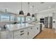 Spacious kitchen island with marble countertop, pendant lighting, and open layout at 2205 E Fallen Leaf Ln, Phoenix, AZ 85024