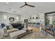 Open concept living room leading into a kitchen with modern decor and a ceiling fan at 2205 E Fallen Leaf Ln, Phoenix, AZ 85024