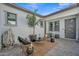 Relaxing outdoor patio area featuring comfortable seating, area rug, and a potted palm tree at 2205 E Fallen Leaf Ln, Phoenix, AZ 85024