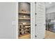 Pantry featuring wooden shelving and a view into the laundry room with washer and dryer at 2205 E Fallen Leaf Ln, Phoenix, AZ 85024