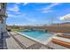 This sparkling pool is framed by lush landscaping, a waterfall feature, and relaxing lounge chairs at 2205 E Fallen Leaf Ln, Phoenix, AZ 85024