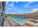 Relaxing backyard pool with lounge chairs, rock waterfall, and a view of the surrounding landscape at 2205 E Fallen Leaf Ln, Phoenix, AZ 85024