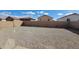 Backyard with a rock surface and surrounding block fence at 22067 W Cantilever St, Buckeye, AZ 85326