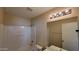 A full bathroom with a tub, shower, vanity, and modern light fixture at 22067 W Cantilever St, Buckeye, AZ 85326