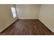 Spacious bedroom with wood-look flooring, bright natural light from the window, and neutral walls at 22067 W Cantilever St, Buckeye, AZ 85326