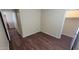 Cozy bedroom featuring wood-look floors, closet, and neutral walls, creating a serene living space at 22067 W Cantilever St, Buckeye, AZ 85326