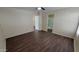 Bright bedroom with wood-look floors, ceiling fan, and neutral paint, adjacent to a bathroom for comfortable living at 22067 W Cantilever St, Buckeye, AZ 85326