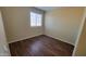 Bright bedroom with wood floors and a window with modern blinds at 22067 W Cantilever St, Buckeye, AZ 85326