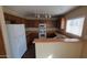 Well-lit kitchen featuring ample counter space, white appliances, and wood cabinetry at 22067 W Cantilever St, Buckeye, AZ 85326