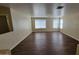 Bright living room with wood-look flooring, large windows, and neutral walls, ready for personalization at 22067 W Cantilever St, Buckeye, AZ 85326