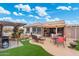 Spacious backyard showcasing a covered patio and manicured landscaping at 23219 N 145Th Dr, Sun City West, AZ 85375