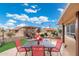 Backyard featuring a dining table, lush green grass, and scenic landscaping at 23219 N 145Th Dr, Sun City West, AZ 85375