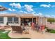 Backyard view featuring a patio, multiple seating options, and attractive landscaping at 23219 N 145Th Dr, Sun City West, AZ 85375