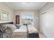 Bedroom with a large window and neutral decor creating a tranquil atmosphere for relaxation and sleep at 23219 N 145Th Dr, Sun City West, AZ 85375