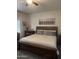 Comfortable bedroom featuring a wooden bed frame and horse artwork above the headboard at 23219 N 145Th Dr, Sun City West, AZ 85375