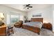 Cozy bedroom with a ceiling fan, carpet, and bay window letting in natural light at 23219 N 145Th Dr, Sun City West, AZ 85375