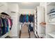 Well-organized walk-in closet offers ample space with shelves and rods for efficient storage solutions at 23219 N 145Th Dr, Sun City West, AZ 85375