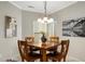 Cozy dining area with chandelier lighting, a breakfast nook, and natural light at 23219 N 145Th Dr, Sun City West, AZ 85375