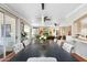 Dining room features an elegant dining table and flows to the living area at 23219 N 145Th Dr, Sun City West, AZ 85375