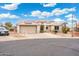 Inviting home exterior featuring a spacious driveway, two-car garage, desert landscaping, and solar panel system at 23219 N 145Th Dr, Sun City West, AZ 85375