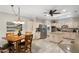 Bright kitchen with a dining table, stainless steel appliances, tile flooring, and plenty of cabinet space at 23219 N 145Th Dr, Sun City West, AZ 85375