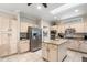 Spacious kitchen featuring a center island, stainless appliances, and tile flooring at 23219 N 145Th Dr, Sun City West, AZ 85375