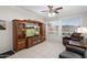 Comfortable living room with large windows, tile flooring, and an entertainment center at 23219 N 145Th Dr, Sun City West, AZ 85375