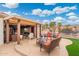 Spacious covered patio perfect for entertaining, featuring stylish outdoor furniture and desert landscaping at 23219 N 145Th Dr, Sun City West, AZ 85375