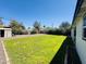 Expansive backyard featuring lush grass and privacy landscaping, perfect for relaxation and recreation at 2450 E Clarendon Ave, Phoenix, AZ 85016