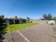 Large backyard features a mix of grass and gravel areas, fully fenced for privacy and security at 2450 E Clarendon Ave, Phoenix, AZ 85016