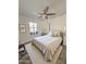 Cozy bedroom with a ceiling fan, plush carpet, and ample natural light at 2450 E Clarendon Ave, Phoenix, AZ 85016