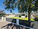Charming single-story home with a well-manicured lawn, secure fence, and mature trees at 2450 E Clarendon Ave, Phoenix, AZ 85016