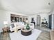 Open-concept living room with hardwood floors, neutral color palette, and recessed lighting at 2450 E Clarendon Ave, Phoenix, AZ 85016