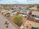 Aerial view of a neighborhood showcasing homes with solar panels, private yards, and mountain views at 25320 W Heathermoor Dr, Buckeye, AZ 85326