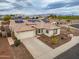 Aerial view of a home showing solar panels, desert landscaping, and a well-maintained front yard and driveway at 25320 W Heathermoor Dr, Buckeye, AZ 85326