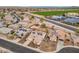 Picture of a charming neighborhood with solar-paneled homes, lush greenery, and well-maintained streets at 25320 W Heathermoor Dr, Buckeye, AZ 85326