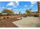 A spacious backyard with patio seating under the sunny blue sky at 25320 W Heathermoor Dr, Buckeye, AZ 85326