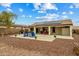 A spacious backyard with an outdoor seating and desert landscaping at 25320 W Heathermoor Dr, Buckeye, AZ 85326