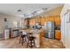 Well-lit kitchen features stainless appliances, an island with seating, and lots of cabinet space at 25320 W Heathermoor Dr, Buckeye, AZ 85326