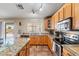 Updated kitchen featuring granite countertops, stainless steel appliances, and ample cabinet space at 25320 W Heathermoor Dr, Buckeye, AZ 85326