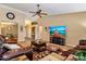 Comfortable living room featuring a ceiling fan, decorative rug, and spacious layout for relaxing and entertaining at 25320 W Heathermoor Dr, Buckeye, AZ 85326