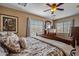 Main bedroom with wooden furniture and natural light from two windows at 25320 W Heathermoor Dr, Buckeye, AZ 85326