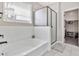 Modern bathroom featuring a soaking tub with white subway tile surround and a glass-enclosed shower at 25583 S 224Th Pl, Queen Creek, AZ 85142