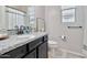 Bathroom features a granite countertop, black cabinets, and modern fixtures at 25583 S 224Th Pl, Queen Creek, AZ 85142